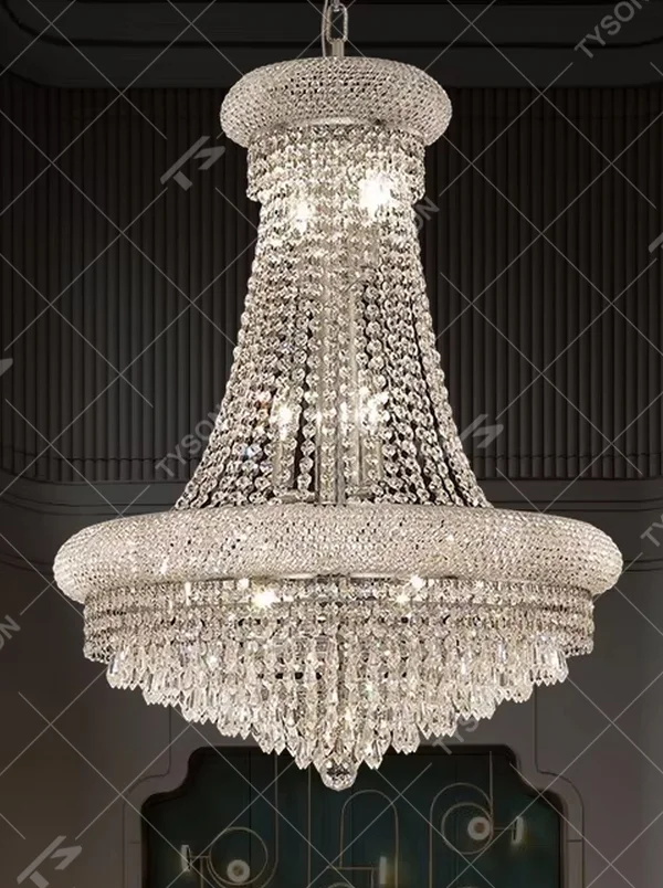This is an European-style luxurious pyramid-shaped crystal chandelier, featuring a gold metal frame paired with multi-layer crystal strings and crystal pendants. Its shape resembles a brilliant palace dome, emitting gorgeous and dazzling light, serving both lighting and decorative purposes, suitable for villa high-ceiling living rooms, hotel lobbies, banquet halls, high-end clubs and other scenarios.