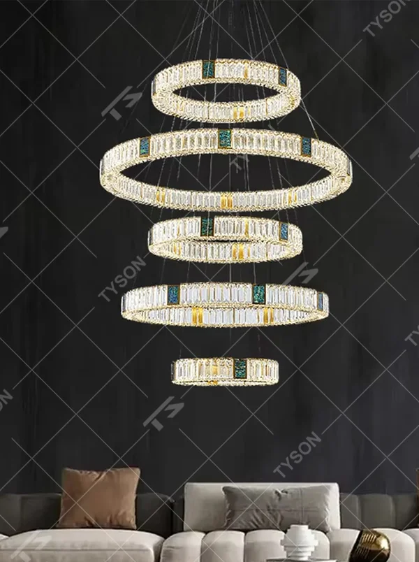 This is a light luxury artistic spiral crystal chandelier, featuring multi-layered circular crystal strips paired with a gold metal frame and emerald accents, shaped like a flowing tornado. Light refracts through the crystals to create brilliant and luxurious lighting effects, serving both lighting and artistic decoration purposes, suitable for high-ceiling spaces such as villa high-ceiling living rooms, duplex voids, hotel lobbies, and high-end clubs.
