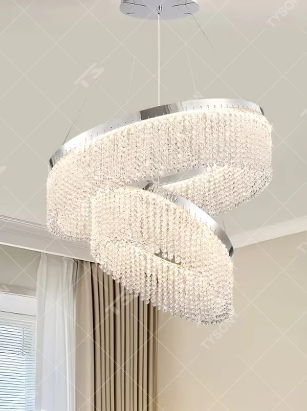 Modern light luxury double-ring spiral crystal chandelier, composed of dense crystal particles and a silver metal frame, presenting a flowing spiral shape. It emits brilliant and soft light, combining artistic decorativeness and lighting function, suitable for core lighting and atmosphere creation in living rooms, dining rooms, villa high-ceiling spaces, etc.