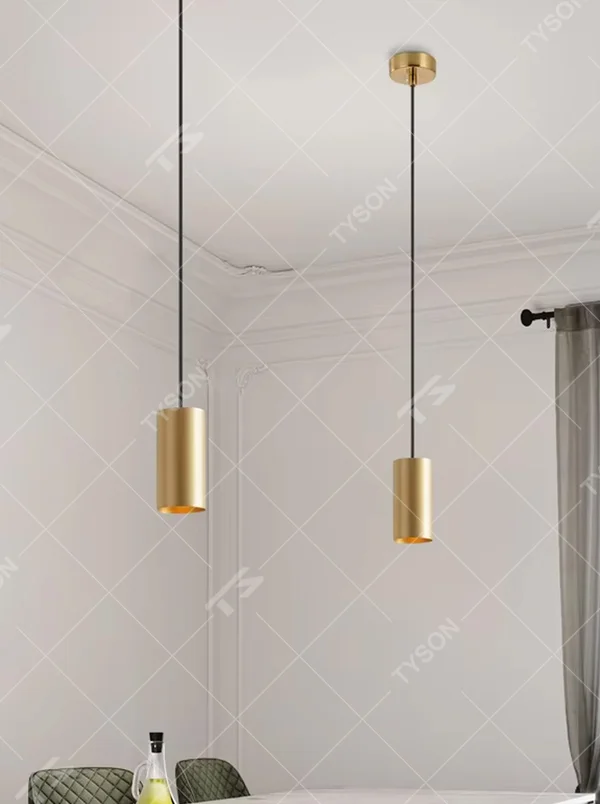 This is a modern light luxury gold cylindrical triple-head pendant light, featuring a linear bronze metal base paired with cylindrical lamp bodies, with a staggered hanging design that is simple and neat. It emits soft and uniform light, serving both lighting and decorative purposes, suitable for dining rooms, bars, minimalist living rooms and other scenarios.