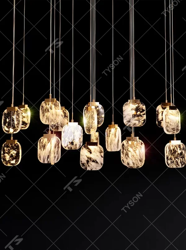 This is a light luxury style duplex crystal chandelier, featuring a gold circular base paired with staggered and hanging marble-patterned crystal blocks. Light refracts through the crystals to create brilliant and luxurious lighting effects, serving both lighting and artistic decoration purposes, suitable for high-ceiling spaces such as villa high-ceiling living rooms, duplex voids, hotel lobbies, and spiral staircases.