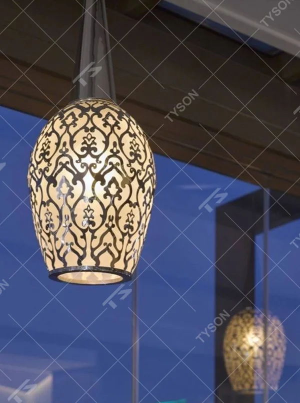 This light luxury black-gold hollow egg-shaped chandelier features retro scroll patterns carved from metal, with warm light refracting delicate shadows through the hollow texture, serving both lighting and decorative purposes, suitable for light luxury spaces such as restaurants and hotel corridors.