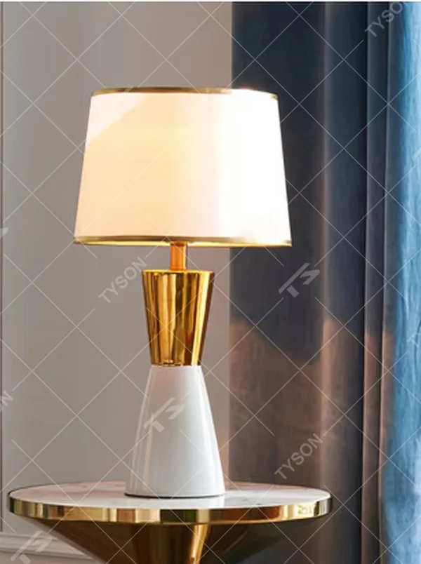 This is a light luxury black-gold table lamp, with a black fabric lampshade edged with gold trim, and a cone-shaped base with a black-gold color block design, featuring both decorative and lighting functions, ideal for high-end indoor scenarios such as bedroom nightstands and living room side tables.