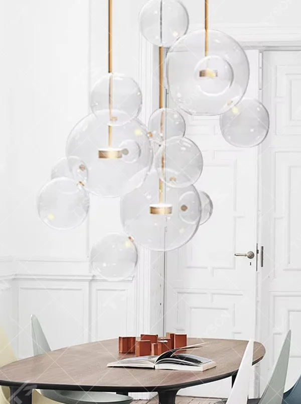 A modern light luxury style bubble-shaped chandelier, suspended by gold wires, paired with transparent glass bubble lampshades of varying sizes. It emits a soft and transparent glow when lit, combining decorative appeal with practical illumination, ideal for creating a dreamy and light space atmosphere.