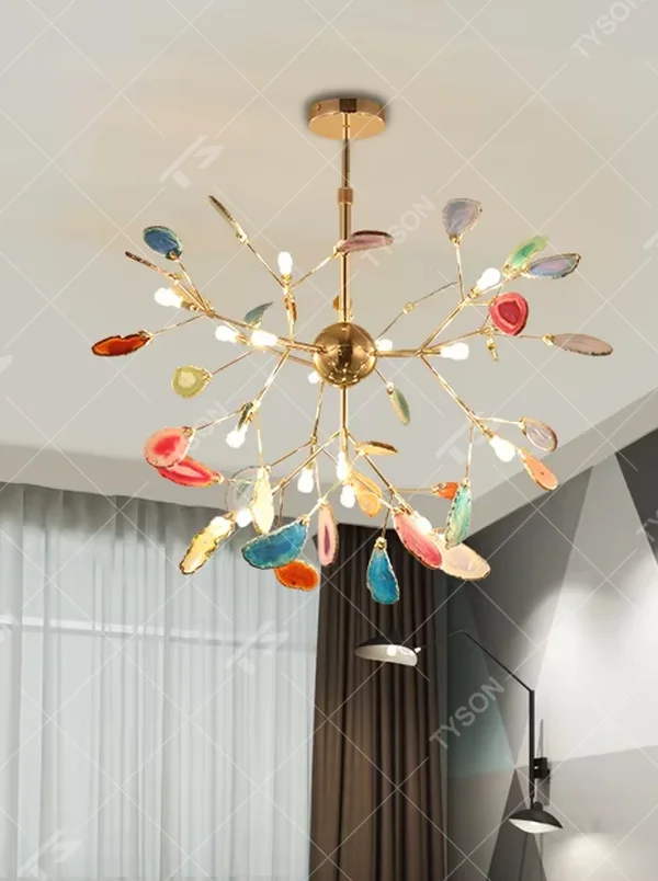 A modern art style linear chandelier, featuring a gold metal branch-like frame with suspended natural colorful agate slices. It emits soft and vibrant light when lit, combining artistic decoration with lighting functionality, ideal for creating a romantic and lively space atmosphere.
