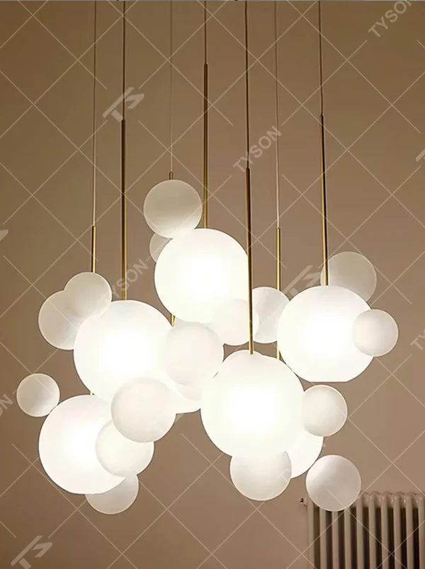 A modern dreamy cloud bubble chandelier, composed of multiple frosted glass balls of varying sizes paired with gold suspension rods. It emits soft and even light when lit, combining decorative appeal with practical illumination, ideal for creating a romantic and soothing space atmosphere.
