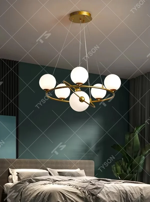 A modern light luxury style planetary orbit chandelier, featuring a gold metal ring frame paired with milky white glass glowing spheres, shaped like planets orbiting a star. It emits a soft and uniform glow when lit, combining decorative appeal with practical illumination, ideal for creating a minimalist and sophisticated space atmosphere.