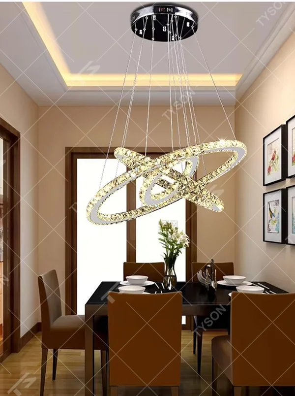 This light luxury black-gold interlaced ring crystal chandelier features a multi-layer flowing ring shape made of metal frames and crystal strips, with light refracting a brilliant halo through the crystals, serving both lighting and decorative purposes, suitable for modern light luxury spaces such as living rooms and dining rooms.