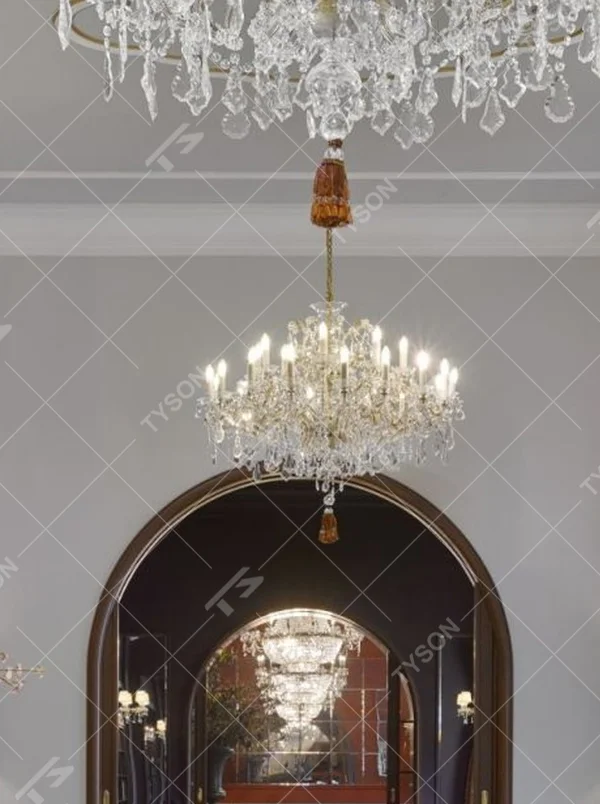 This European court-style multi-layer crystal chandelier features a gold metal frame paired with dense faceted crystals and candle-shaped lamp heads, with light refracting a brilliant halo through the crystals, serving both lighting and decorative purposes, suitable for luxury spaces such as high-end restaurants and hotel lobbies.