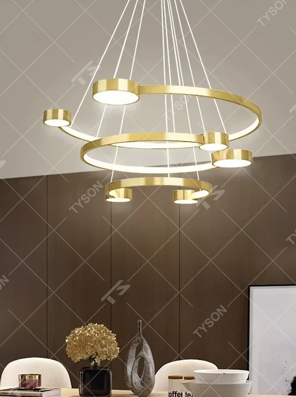 A modern light luxury multi-layer ring floating chandelier, featuring a golden metal ring structure paired with LED light strips and a bottom circular luminous panel. It has an adjustable suspension rod design, combining lighting and decorative functions, ideal for creating an elegant and high-end space atmosphere.