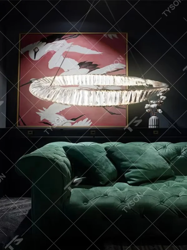 A light luxury and glamorous oval crystal chandelier, constructed with multiple transparent crystal panels joined into a ring-shaped body. It emits a soft and brilliant glow when lit, combining artistic decoration with lighting functionality, ideal for creating a high-end and sophisticated space atmosphere.