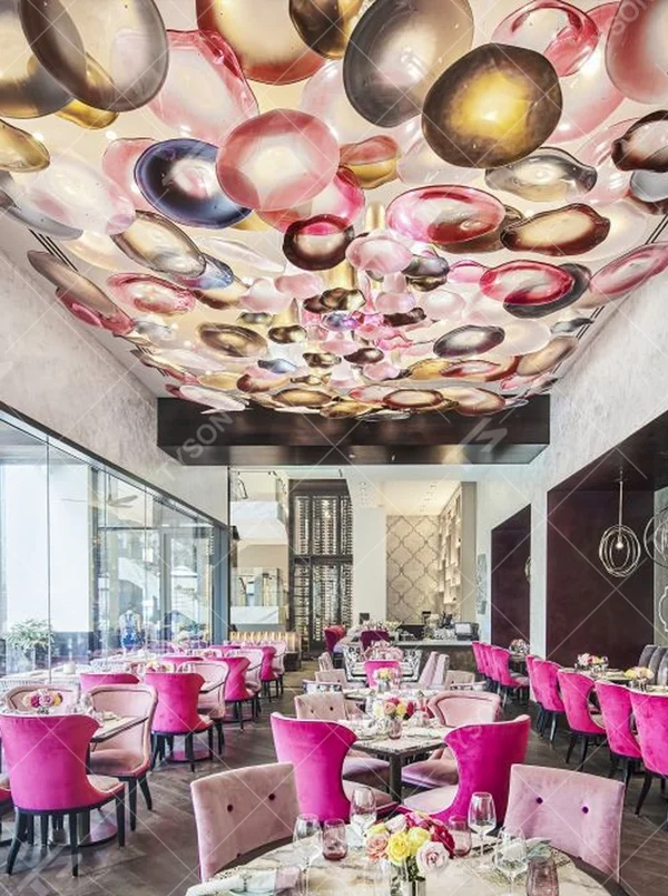 This iridescent bubble art ceiling lamp is composed of a large number of gradient-colored glass discs in pink-gold, purple-brown, etc., arranged staggered to cover the ceiling like flowing colorful light spots. Light refracts through the glass to emit a soft and transparent halo, serving both lighting and decorative purposes, suitable for trendy commercial spaces such as internet-famous restaurants and art bars.
