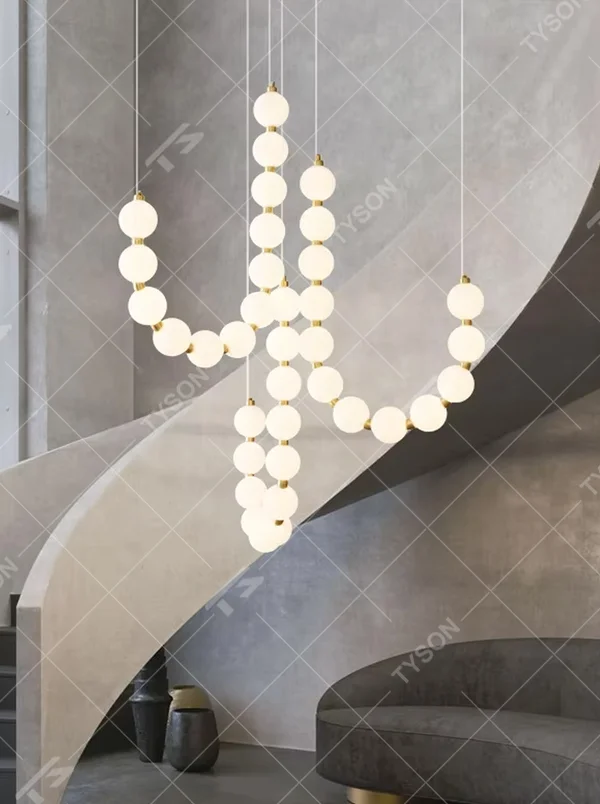 Modern Light Luxury Curved Beaded Chandelier, Milk white spherical lamps connected in a wave shape with gold metal details, serves both lighting and decorative purposes, ideal for duplex stairwells, high-ceiling living rooms, villas and other high-ceiling spaces.
