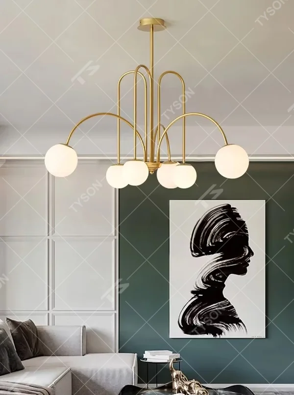 A multi-head chandelier combining modern light luxury and French retro styles, featuring a gold metal curved branch frame paired with milky white glass glowing spheres of varying sizes. It emits soft and uniform warm light when lit, combining decorative appeal with practical illumination, ideal for creating an elegant and dynamic space atmosphere.
