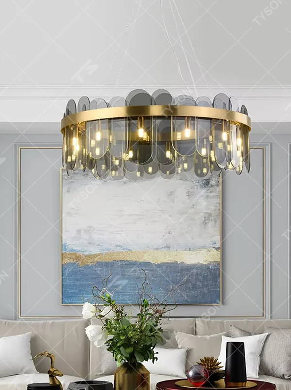 A modern light luxury style ring chandelier, featuring a gold metal frame paired with gradient transparent circular glass panels. It emits a soft and brilliant glow when lit, combining decorative appeal with practical illumination, ideal for creating an elegant and sophisticated space atmosphere.
