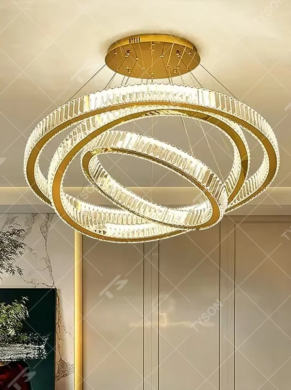 This is a light luxury multi-layer ring crystal chandelier, with a gold metal frame and high-transparency crystal strips, creating a brilliant and luxurious light effect through staggered ring structures, with both decorative and lighting functions, ideal for high-end indoor spaces such as villa living rooms and duplex high-ceiling spaces.