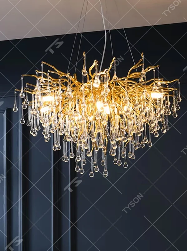 This light luxury golden branch crystal rain linear chandelier features a bionic branch structure made of gold metal, paired with crystal water drop pendants, with brilliant and soft light, serving both lighting and decorative purposes, suitable for modern light luxury spaces such as dining rooms and living rooms.
