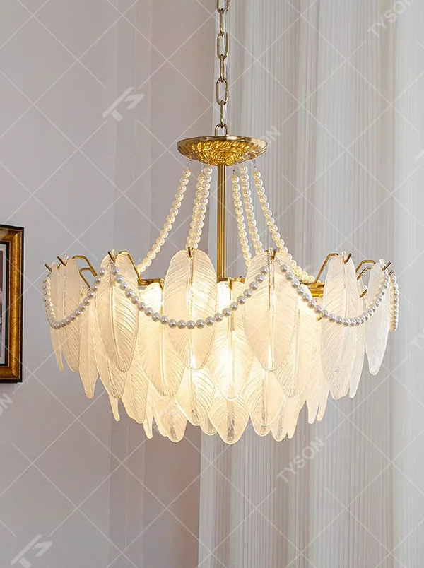 A French light luxury style feather glass chandelier, featuring a gold metal frame paired with double-layer feather-textured glass panels and pearl chain decorations. It emits a soft and warm glow when lit, combining decorative appeal with practical illumination, ideal for creating a romantic and elegant space atmosphere.
