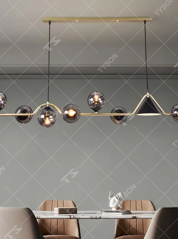 Modern light luxury black-gold contrasting dining chandelier, with a long black metal frame paired with a golden conical lampshade and transparent glass ball lampshades, featuring a minimalist and flexible shape, combining decorative and lighting functions, suitable for dining rooms, bars and other modern style spaces.