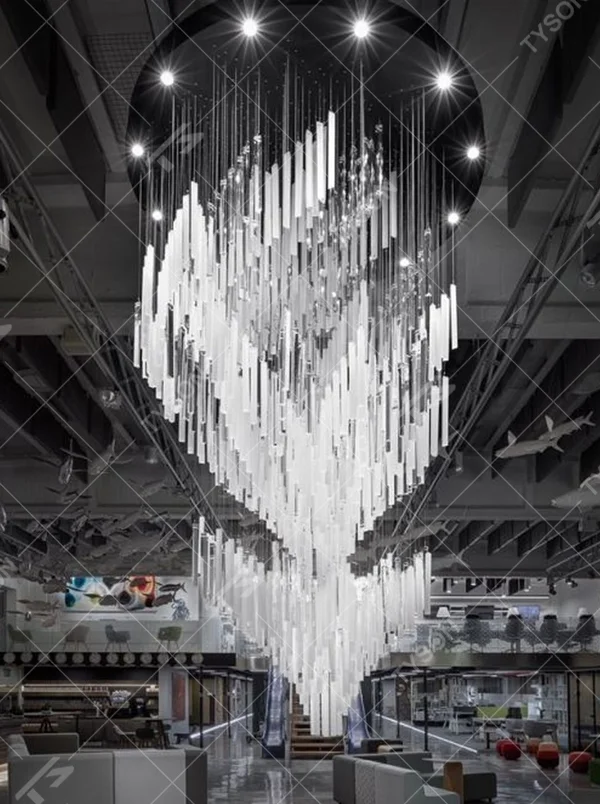 This modern industrial-style art chandelier consists of a large number of white acrylic strips hung staggered by metal wires, extending downward in a waterfall shape from a circular ceiling plate. Light passes through the strips to emit a transparent and soft halo, serving both lighting and decorative purposes, suitable for high-ceiling commercial spaces such as cultural and creative parks and art exhibition halls.