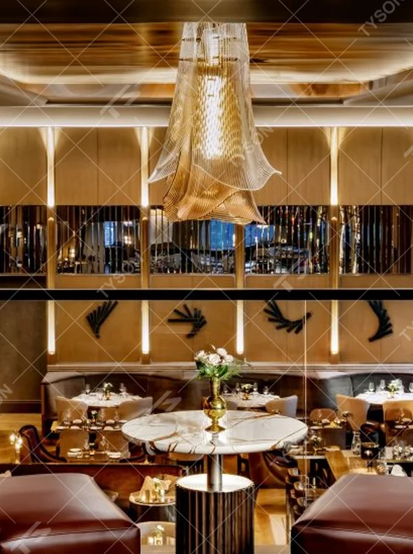 This modern light luxury art chandelier is made of metal mesh/acrylic material with a layered streamlined shape, hanging down like flowing fabric. Warm light passes through the material to emit a soft and transparent halo, serving both lighting and decorative purposes, suitable for high-end commercial spaces such as luxury restaurants and clubs.