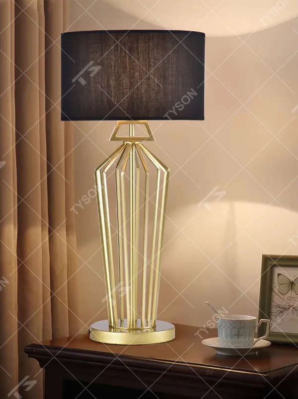 Modern Light Luxury Geometric Hollow Metal Table Lamp, Black Cylindrical Fabric Lampshade, Gold Prism Hollow Metal Lamp Body, Serves Both Lighting and Decorative Purposes, Ideal for Bedrooms, Living Rooms, Studies, Hotel Guest Rooms and Other Light Luxury Spaces.