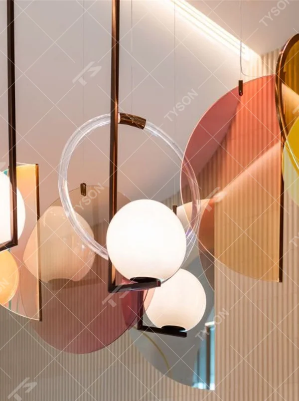 Modern Art Combination Pendant Light, Composed of Milk White Spherical Lamps, Colorful Translucent Disc Decorations and Copper Metal Frames, Serves Both Lighting and Decorative Purposes, Ideal for Art Galleries, Light Luxury Restaurants, Sales Centers, High-End Clubs, etc.