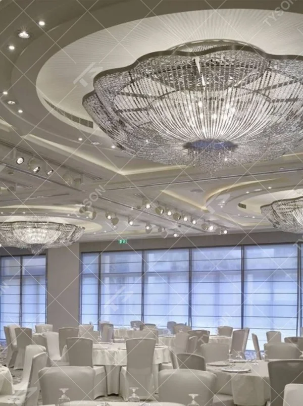 This large petal-shaped crystal ceiling lamp consists of radial crystal strips forming a hollow petal shape, with light refracting a brilliant halo through it, serving both lighting and decorative purposes, suitable for high-end luxury spaces such as hotel banquet halls and large clubs.