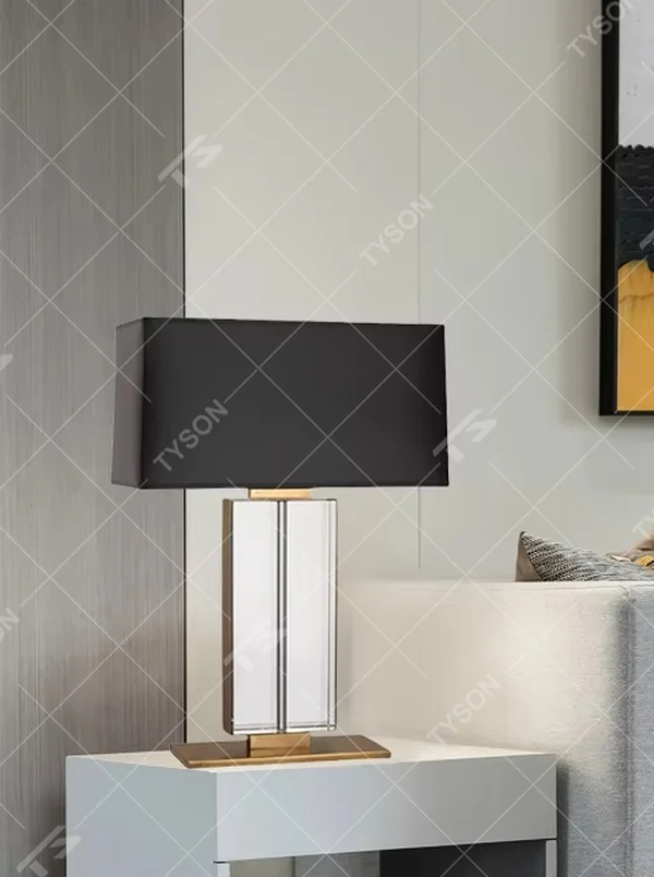 This is a modern light luxury crystal column table lamp, with a black rectangular fabric lampshade paired with a transparent cut crystal column base, accented with gold metal details, featuring both decorative and lighting functions, ideal for high-end indoor scenarios such as living room side tables and bedroom nightstands.