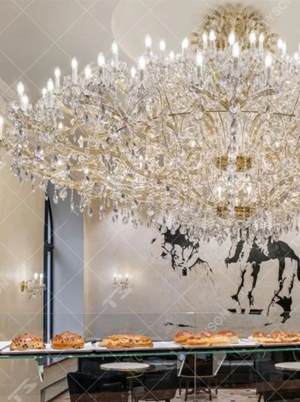 This is a luxurious large chandelier, supported by a gold metal frame with multi-layer crystal pendants, featuring a blooming and gorgeous shape, with brilliant and dazzling light, both decorative and lighting functions, ideal for large commercial spaces such as high-end restaurants and hotel lobbies.
