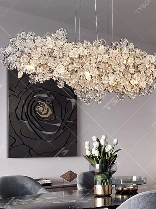 This light luxury silver diamond cloud chandelier is composed of a large number of layered silver metal discs with diamond-like texture, presenting a fluffy and light cloud shape. Light refracts through the discs to emit a brilliant and soft halo, serving both lighting and decorative purposes, suitable for modern light luxury spaces such as living rooms and dining rooms.