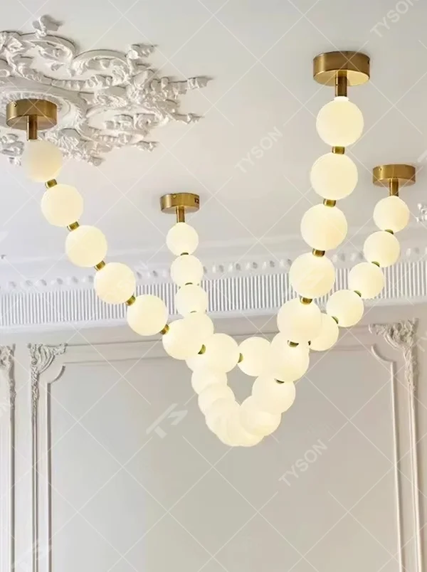 Modern Light Luxury Curved Beaded Chandelier, Milk White Spherical Lampshades Connected in a Wave Shape, Gold Metal Base, Serves Both Lighting and Decorative Purposes, Ideal for Living Rooms, Dining Rooms, Open Kitchens, etc.