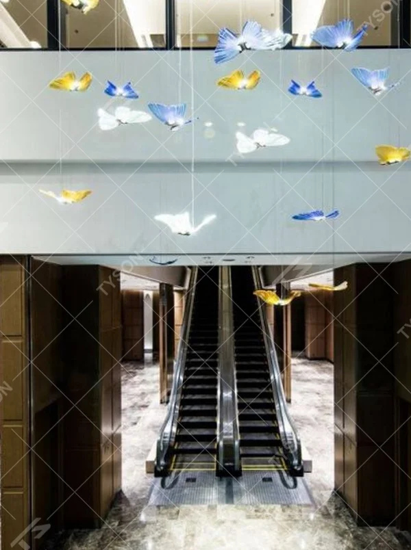 Modern artistic butterfly-shaped suspended chandelier, made of colored glass/acrylic to create a realistic butterfly form, paired with adjustable metal suspension rods, combining decorative and ambient lighting functions, suitable for hotel lobbies, high-end clubs, art exhibition halls and other spaces.
