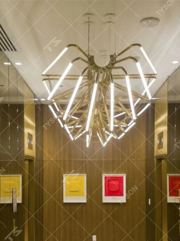 This modern art branch chandelier features an interlaced branch structure made of gold metal, paired with LED strips to form a starburst shape, with soft and visually striking light, serving both lighting and decorative purposes, suitable for high-end modern spaces such as elevator lobbies and clubs.