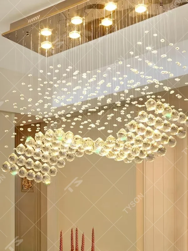 This modern light luxury rectangular crystal ceiling lamp is composed of a large number of hanging crystal bead strings, presenting a layered waterfall shape. The light refracts through the crystal to emit a brilliant and transparent glow, serving both core lighting and decorative purposes, suitable for modern light luxury style spaces such as living rooms and dining rooms.