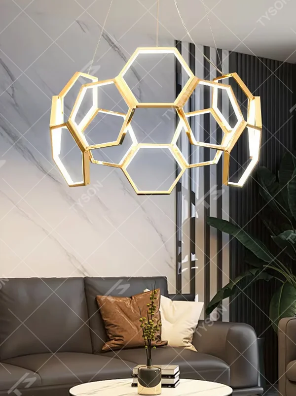 A modern light luxury style honeycomb-shaped chandelier, featuring a honeycomb geometric frame made of gold metal with built-in LED strips. It emits soft and uniform light when lit, combining artistic decoration with lighting functionality, ideal for creating a high-end and futuristic space atmosphere.
