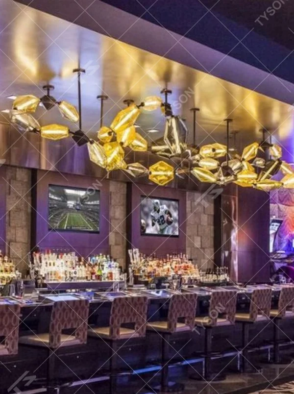 This modern art liuli chandelier features black metal brackets connecting irregular golden liuli leaves, with transparent and soft light, serving both lighting and decorative purposes, suitable for modern entertainment commercial spaces such as bars and high-end clubs.