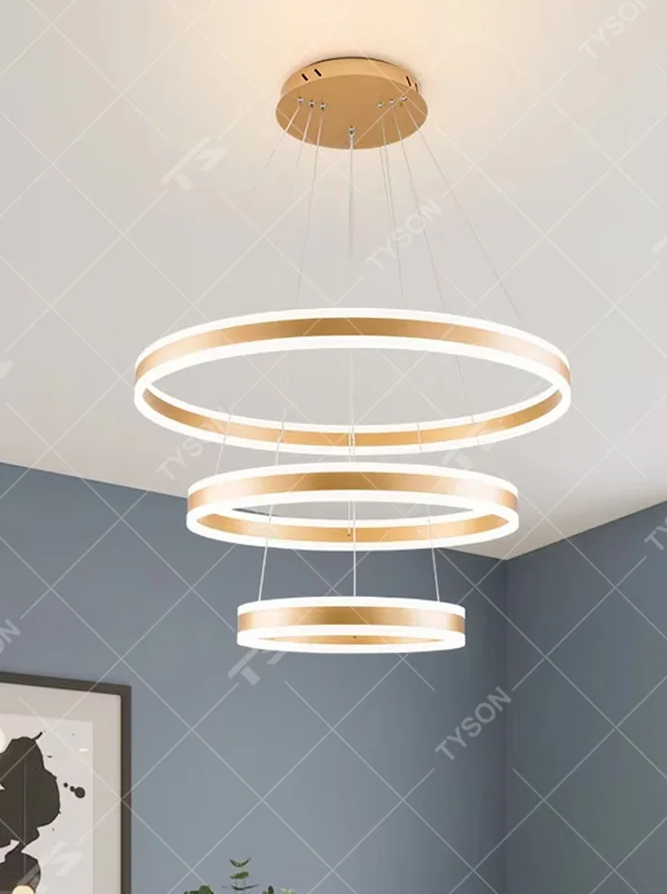 A modern light luxury three-tier ring LED chandelier, featuring a gold metal frame with built-in soft light strips and adjustable suspension rods for different ceiling heights, combining lighting and decorative functions, ideal for creating a minimalist and sophisticated space atmosphere.