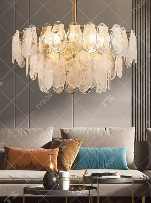 A modern light luxury style ring chandelier, featuring a gold metal frame with layered gradient glass petal panels. It emits a soft and warm glow when lit, combining decorative appeal with practical illumination, ideal for creating an elegant and sophisticated space atmosphere.