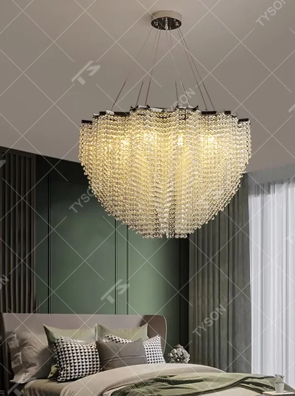 This light luxury heart-shaped crystal chandelier features a full heart shape made of crystal beads, with warm light refracting a brilliant halo through the crystals, serving both lighting and decorative purposes, suitable for modern light luxury spaces such as living rooms and dining rooms.