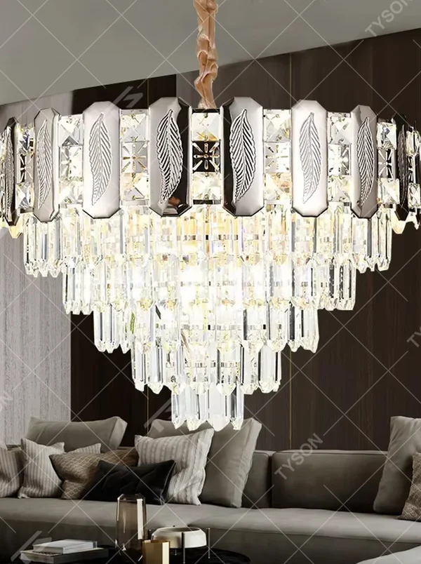 This is a light luxury cascading crystal chandelier, with a top metal frame inlaid with leaf-textured decorative panels and cut crystals, and densely cascading crystal strips hanging below, featuring brilliant and soft light, both decorative and lighting functions, ideal for high-end indoor spaces such as living rooms and dining rooms.