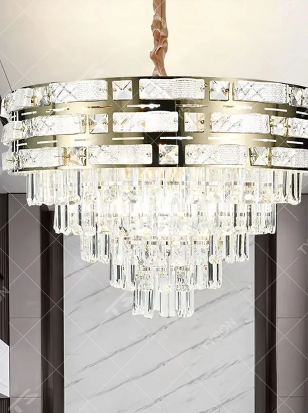 This is a luxurious multi-layer round crystal chandelier, with a gold metal frame inlaid with cut crystal decorations and cascading crystal strips hanging below, featuring brilliant and soft light, both decorative and lighting functions, ideal for high-end indoor spaces such as living rooms and dining rooms.
