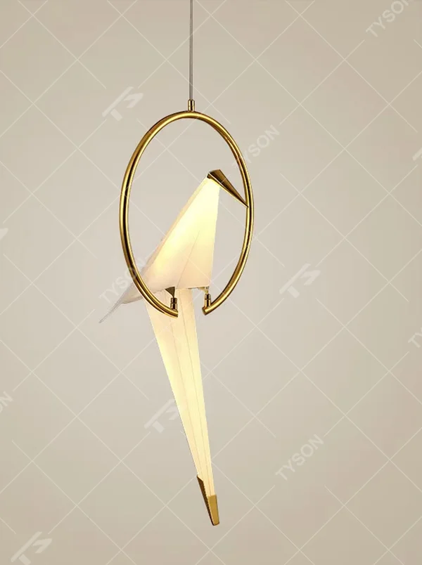 A modern art light luxury style origami crane chandelier, featuring a gold metal ring frame paired with an origami-style white translucent lampshade, shaped like an origami crane perched in a gold ring. It emits a soft and warm glow when lit, combining decorative appeal with practical illumination, ideal for creating an elegant and soothing space atmosphere.