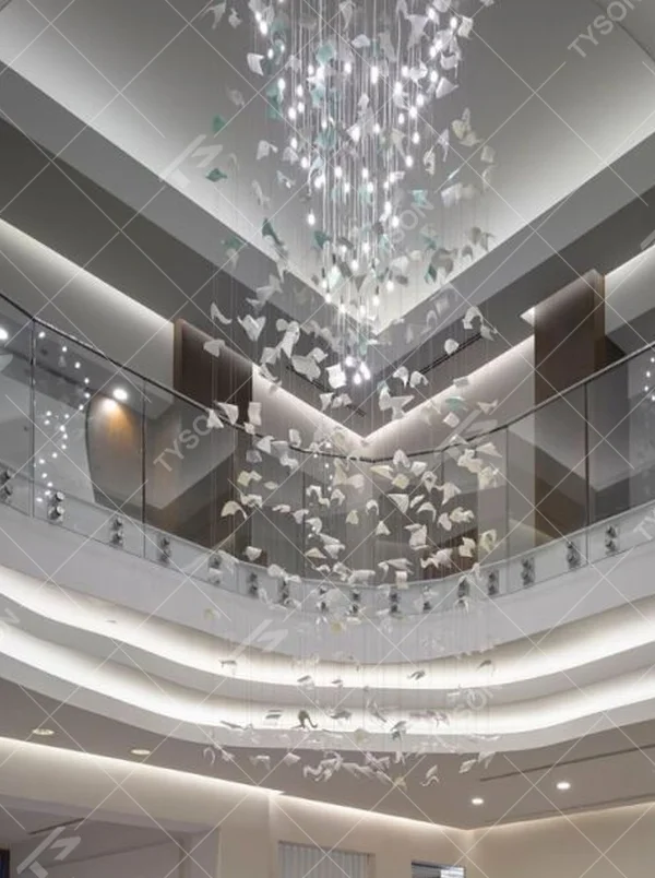 This large butterfly crystal art chandelier features a drooping shape made of transparent butterfly-shaped ornaments and crystal beads, with light refracting a soft halo through it, serving both lighting and installation art purposes, suitable for high-end luxury spaces such as hotel lobbies and high-ceiling clubs.