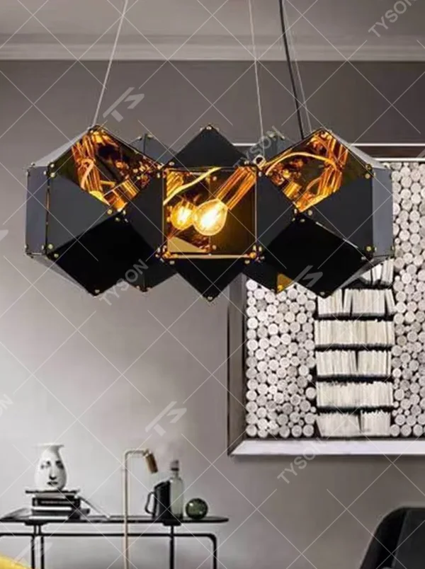 A modern industrial light luxury style geometric splicing chandelier, featuring a black metal polyhedron frame paired with amber glass facets and gold rivet decorations. When lit, the light refracts to create a brilliant effect, combining decorative appeal with practical illumination, ideal for creating a bold and avant-garde space atmosphere.