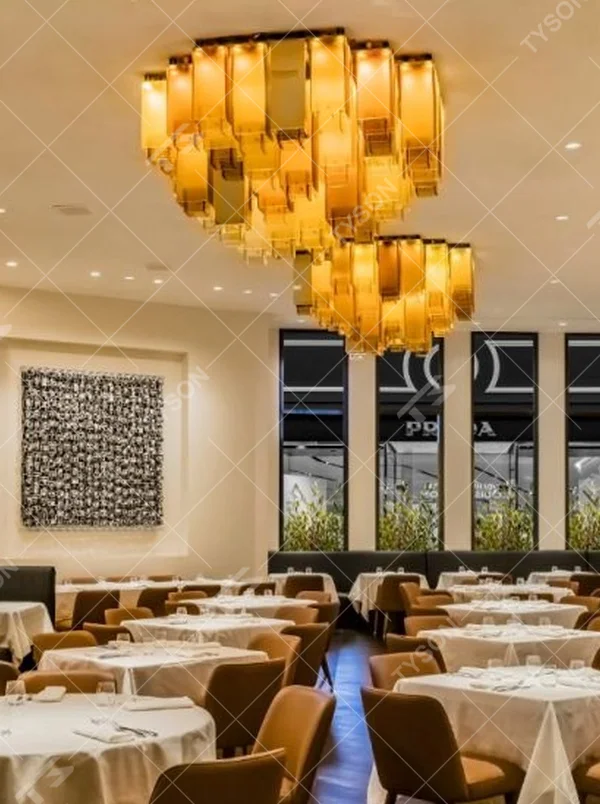 Modern Light Luxury Stacked Square Chandelier, Composed of Layered Amber Acrylic Blocks with Gold Metal Frame, Serves Both Lighting and Decorative Purposes, Ideal for High-End Restaurants, Hotel Lobbies, Clubs, etc.
