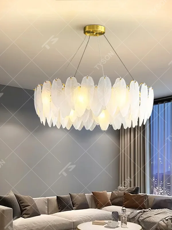 A modern light luxury style ring chandelier, featuring a gold metal frame paired with double-layer feather-shaped gradient glass panels. It emits a soft and warm glow when lit, combining decorative appeal with practical illumination, ideal for creating a romantic and elegant space atmosphere.

