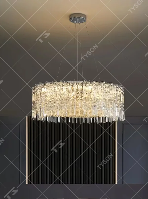 This modern light luxury square crystal chandelier features a silver metal frame, with dense transparent long crystals hanging down to form a square shape. When lit, light refracts through the crystal to emit a brilliant and soft glow, combining an exquisite texture with an ambient atmosphere. Ideal for bedrooms, dining rooms, light luxury apartments, and other spaces, it adds an exquisite and sophisticated touch to modern minimalist or light luxury home environments.