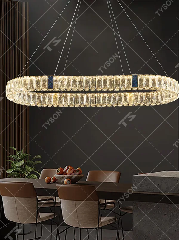 This light luxury and grand multi-layer conical crystal chandelier features a gold metal frame, with vertical-textured glass lampshades on the upper layer and multiple layers of transparent crystal tassels hanging below, creating a full conical shape. When lit, light refracts through the crystal to emit a brilliant and luxurious glow, combining elegant texture with an ambient atmosphere. Ideal for living rooms, dining rooms, villa high-ceiling spaces, and other areas, it adds an elegant and exquisite touch to European light luxury or modern luxury home environments.