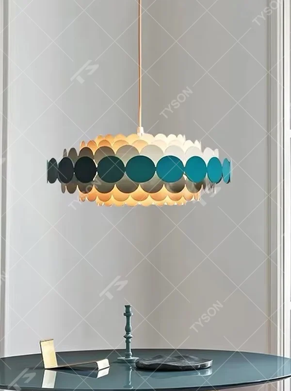 Nordic pop-style gradient disc chandelier, featuring an oval lampshade made of layered colorful discs with a gradient from light beige to deep teal. Light passes through the discs to create soft, gradient lighting effects, combining playfulness and artistry, making it a decorative lighting fixture that enhances space vitality.